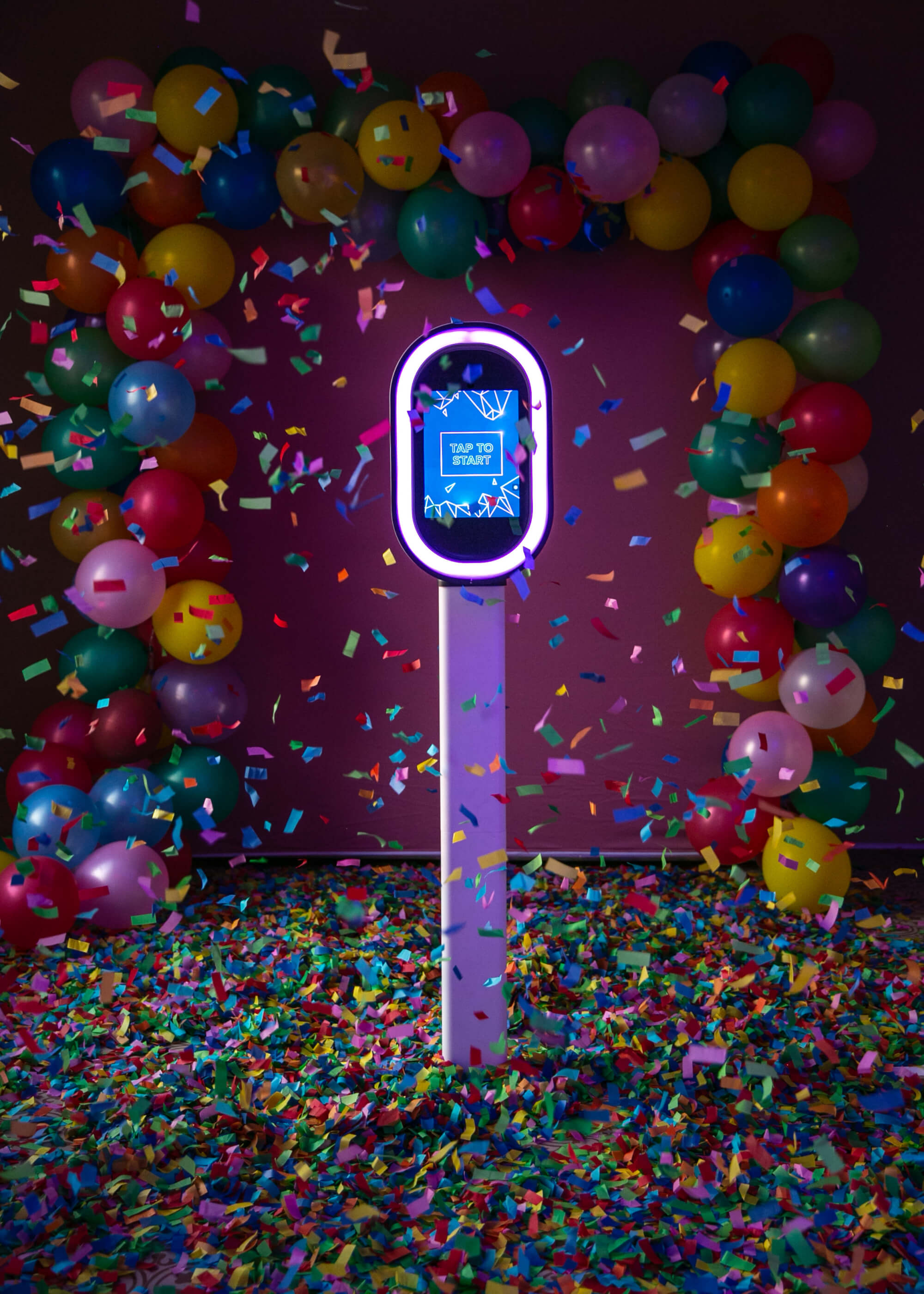 Ozark Pix photo booth kiosk with multi-colored confetti and balloon garland